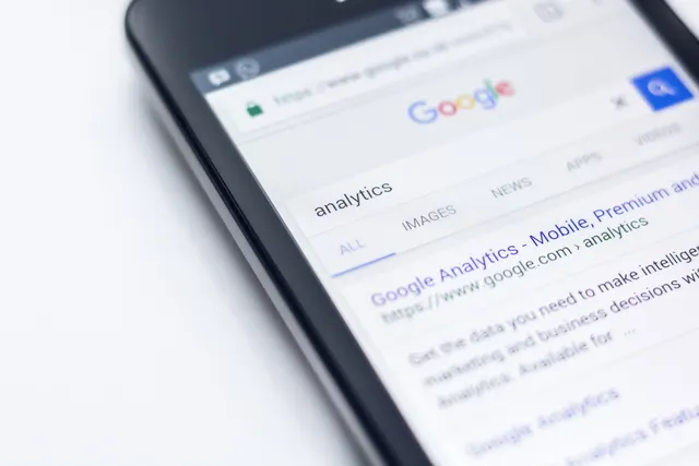 Photograph: A smartphone browser showing a Google search results page for analytics.