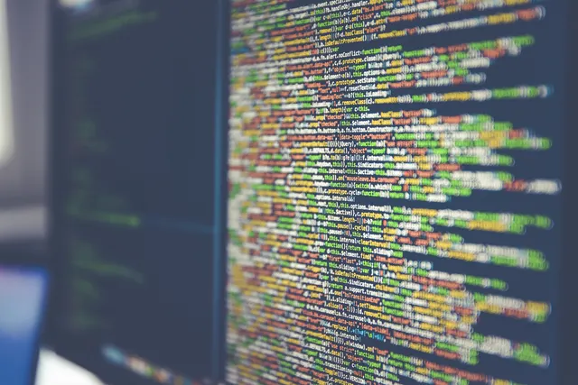 Photograph: Lines of colour-highlighted source code on a computer monitor.