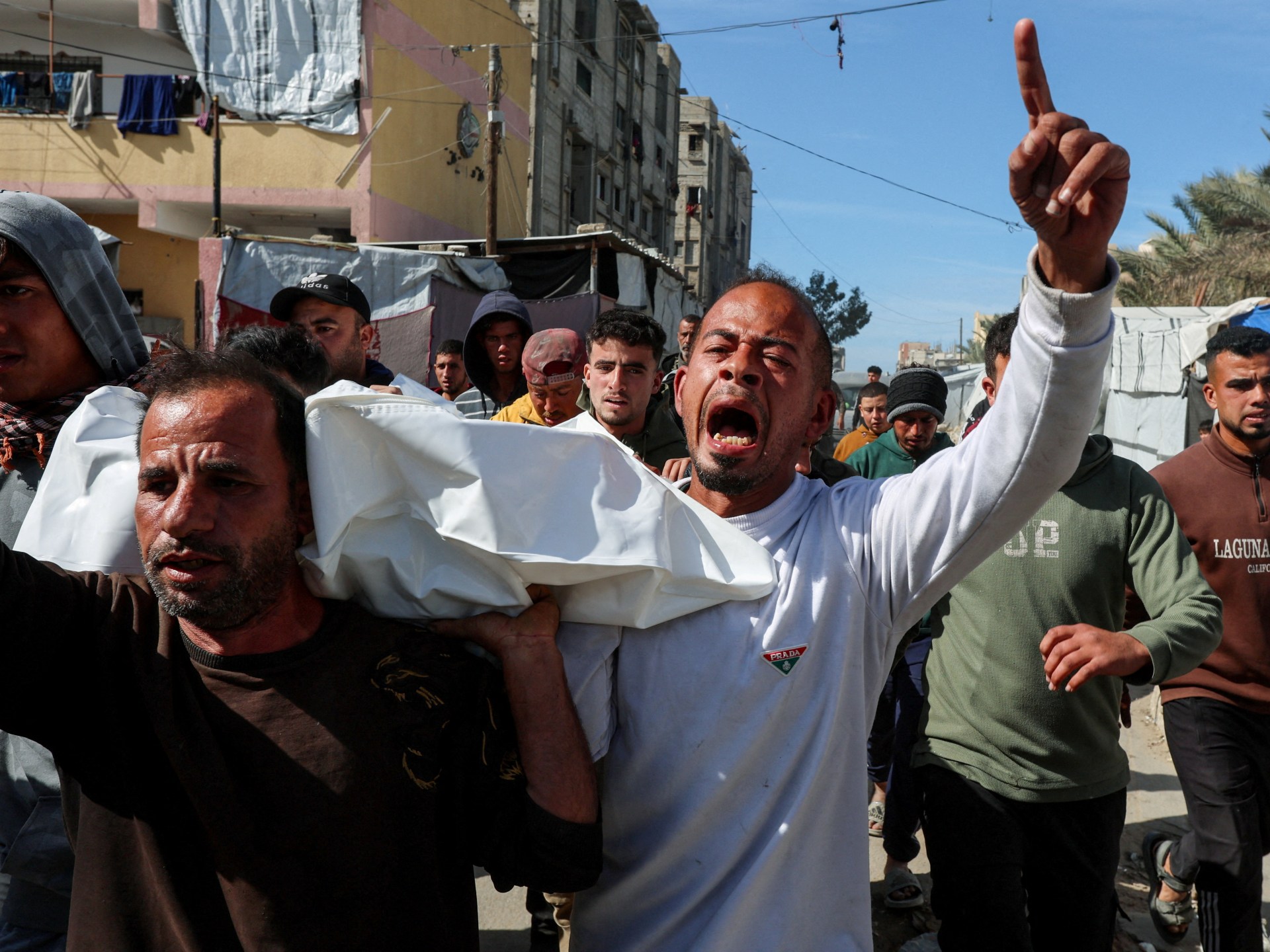 Israel hands over 15 bodies of Palestinians in last stage of captive swap | Gaza News Israel hands over 15 bodies of Palestinians in last stage of captive swap | Gaza News